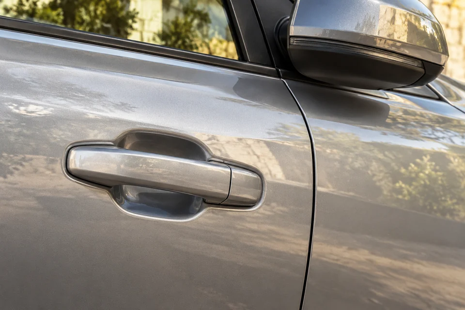 AI-generated illustration of a silver passenger door handle and side-mirror detail