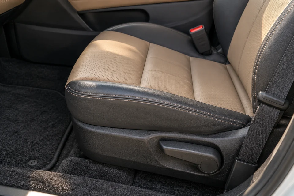 AI-generated illustration of passenger-seat upholstery, a seat belt and an adjustment lever