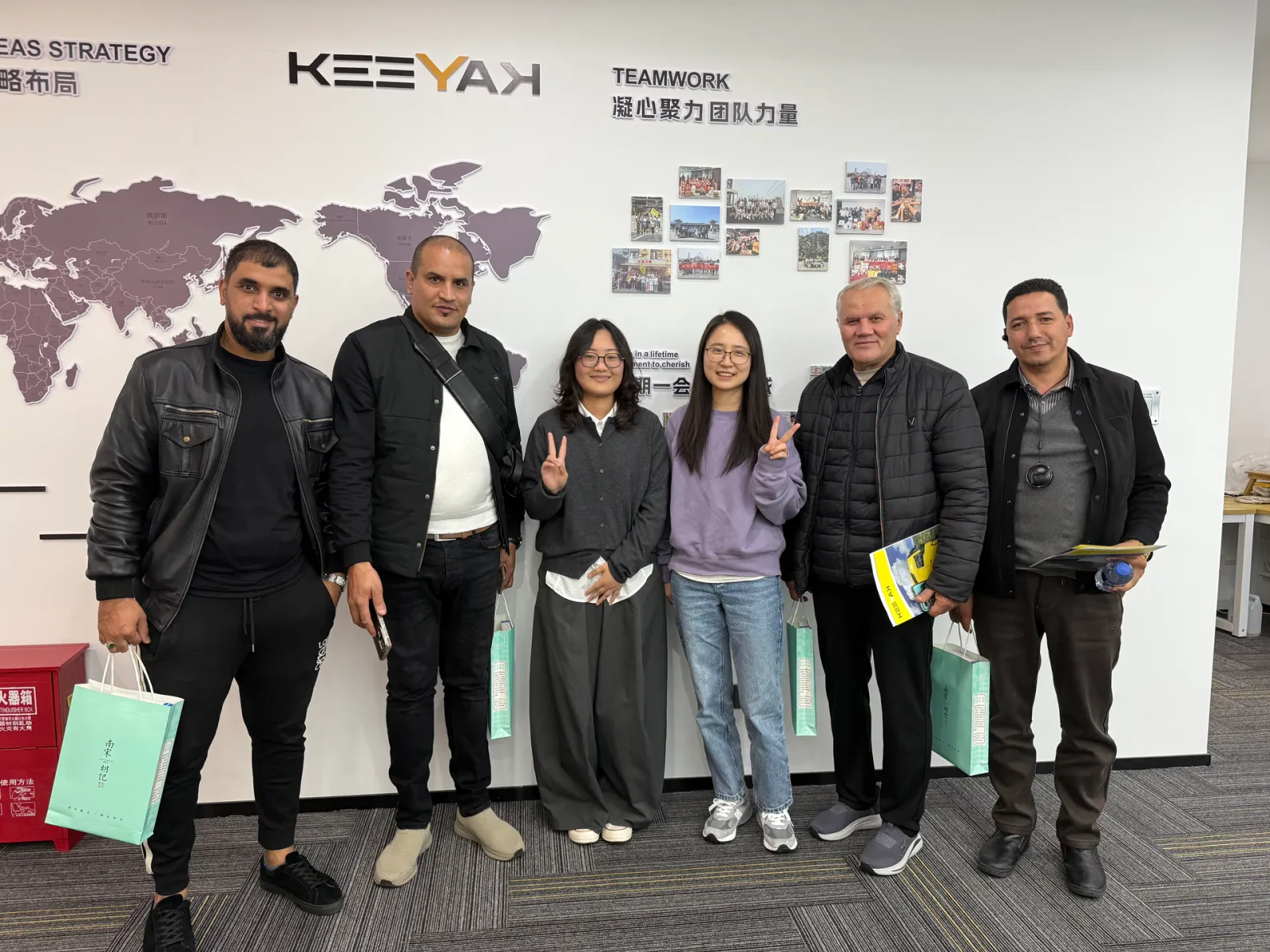 Original company photograph of KEEYAK colleagues and visitors at the office